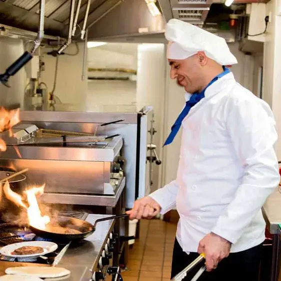 Salmon Creek Chef Created Meals, chef frying a dish.