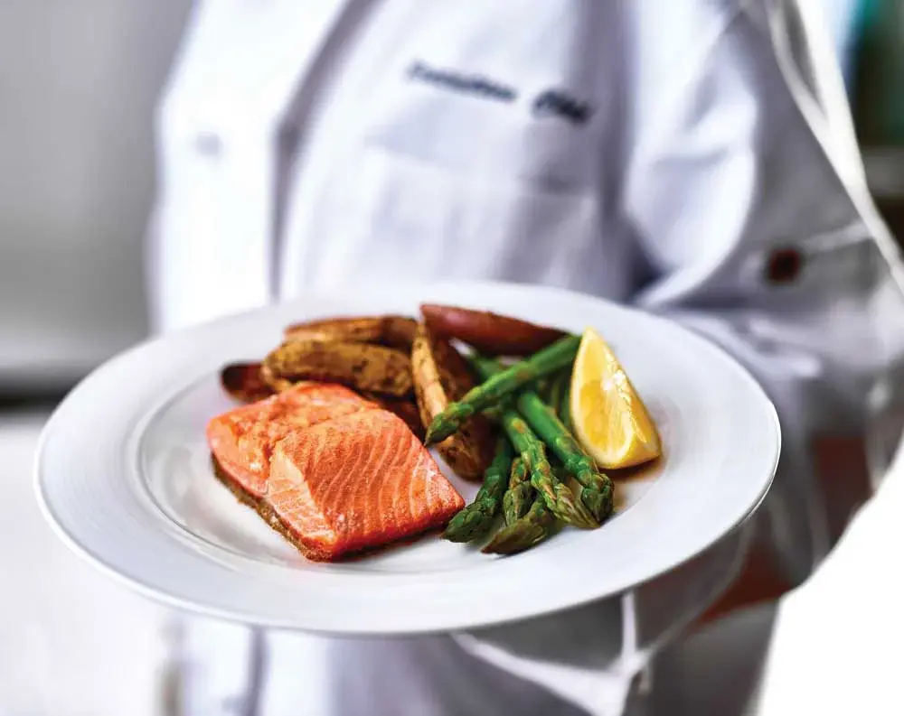 Salmon Creek Chef Created Meals, chef delivering a finished dish.